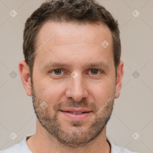 Joyful white adult male with short  brown hair and brown eyes