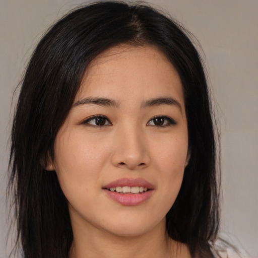 Joyful asian young-adult female with long  black hair and brown eyes