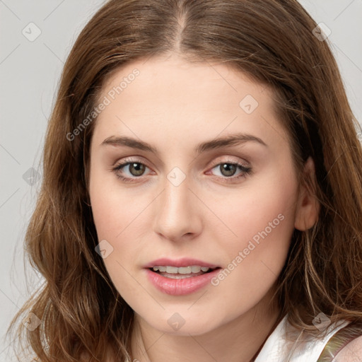 Joyful white young-adult female with long  brown hair and green eyes