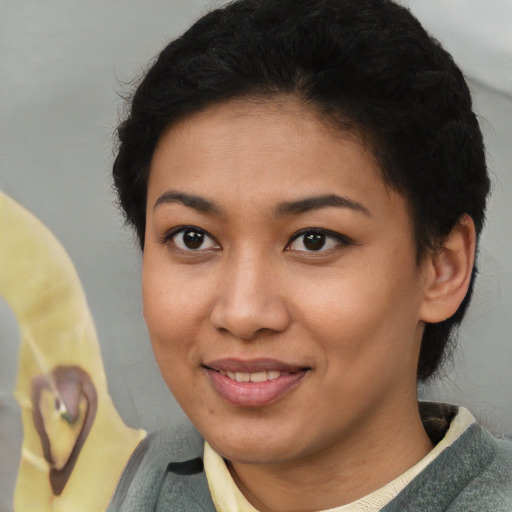 Joyful latino young-adult female with short  brown hair and brown eyes