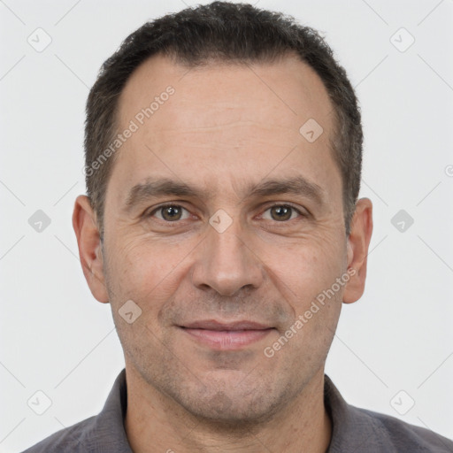 Joyful white adult male with short  brown hair and brown eyes