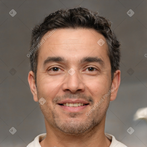 Joyful white adult male with short  brown hair and brown eyes