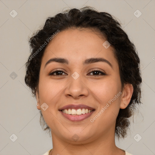 Joyful latino young-adult female with medium  brown hair and brown eyes