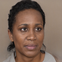 Joyful black adult female with short  brown hair and brown eyes