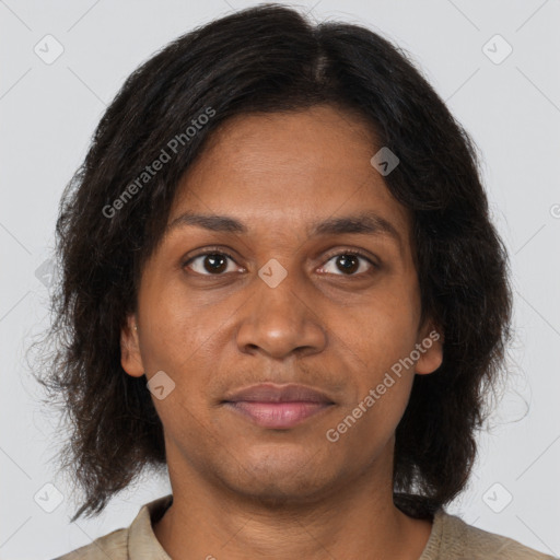 Joyful black young-adult female with long  brown hair and brown eyes