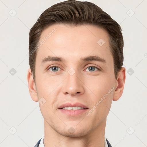 Joyful white young-adult male with short  brown hair and grey eyes