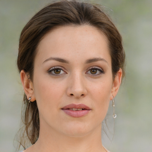 Joyful white young-adult female with medium  brown hair and green eyes