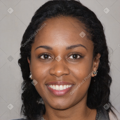 Joyful black young-adult female with long  black hair and brown eyes