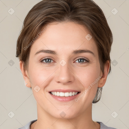 Joyful white young-adult female with short  brown hair and grey eyes