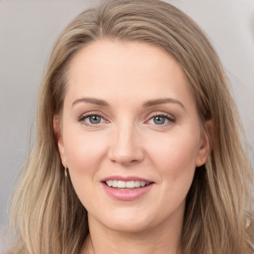 Joyful white young-adult female with long  brown hair and grey eyes