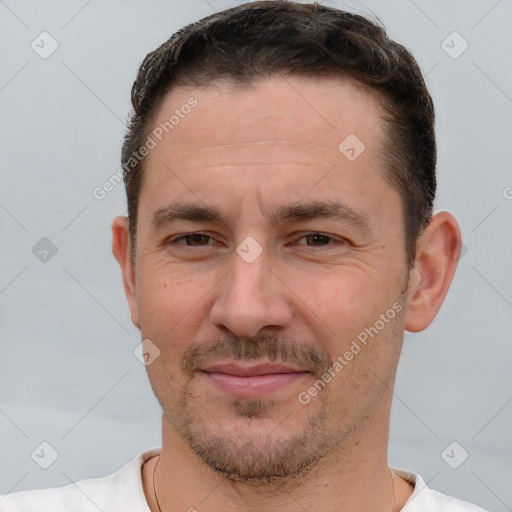 Joyful white adult male with short  brown hair and brown eyes