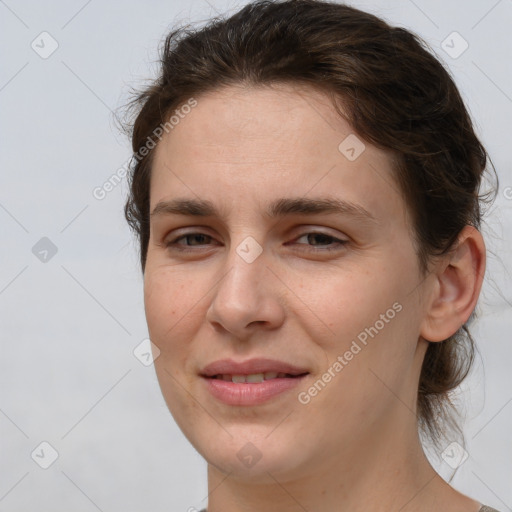 Joyful white young-adult female with medium  brown hair and grey eyes