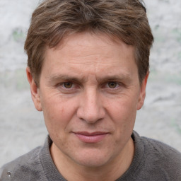 Joyful white adult male with short  brown hair and grey eyes