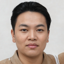 Joyful asian young-adult male with short  black hair and brown eyes