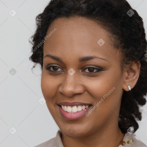 Joyful black young-adult female with long  brown hair and brown eyes