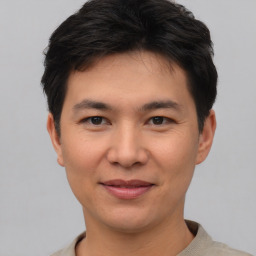 Joyful asian young-adult male with short  black hair and brown eyes