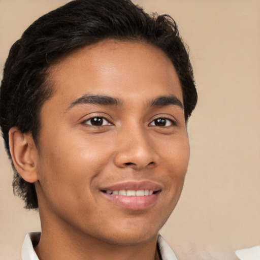 Joyful latino young-adult male with short  brown hair and brown eyes