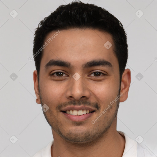 Joyful latino young-adult male with short  black hair and brown eyes