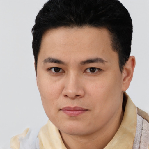 Joyful latino young-adult male with short  brown hair and brown eyes