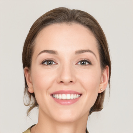 Joyful white young-adult female with medium  brown hair and grey eyes