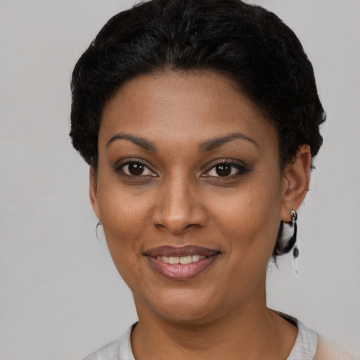 Joyful latino young-adult female with short  black hair and brown eyes