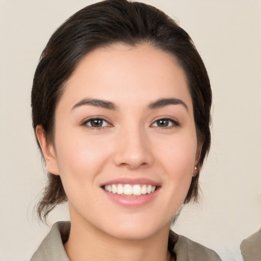 Joyful white young-adult female with medium  brown hair and brown eyes