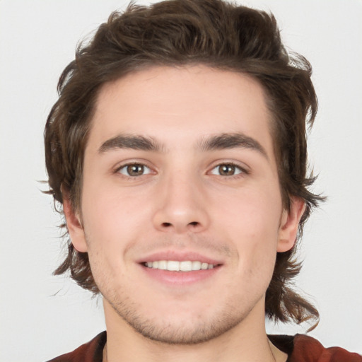 Joyful white young-adult male with medium  brown hair and brown eyes