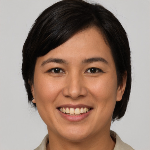 Joyful asian young-adult female with medium  brown hair and brown eyes