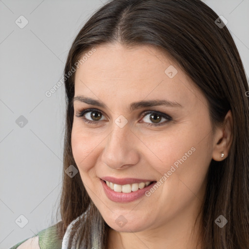 Joyful white young-adult female with long  brown hair and brown eyes