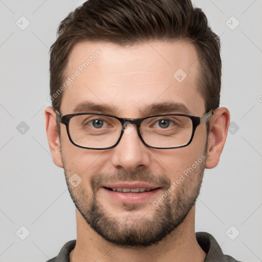 Joyful white young-adult male with short  brown hair and grey eyes