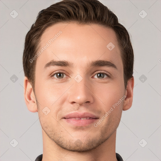 Joyful white young-adult male with short  brown hair and grey eyes