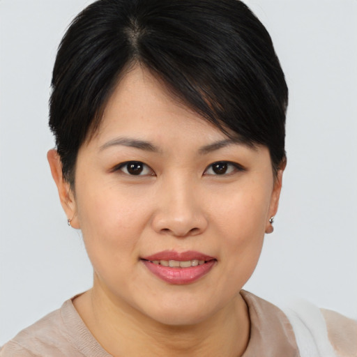 Joyful asian young-adult female with short  brown hair and brown eyes