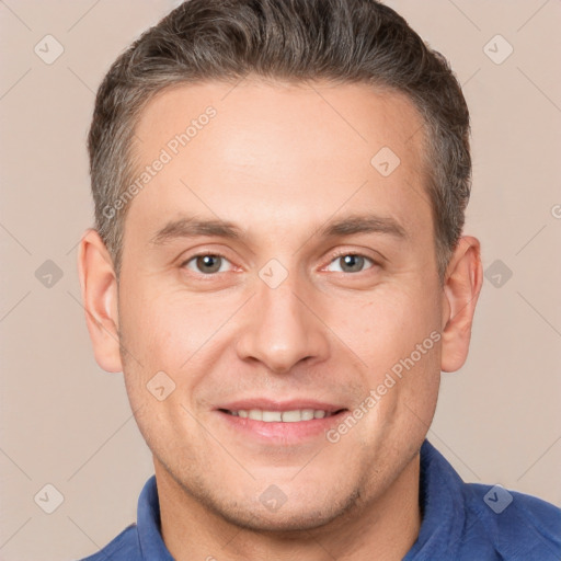 Joyful white adult male with short  brown hair and brown eyes