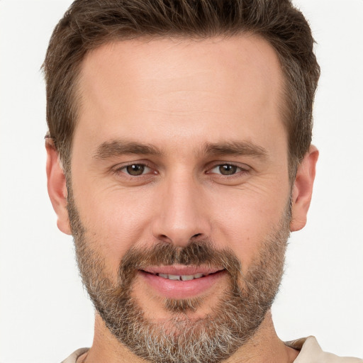 Joyful white adult male with short  brown hair and brown eyes