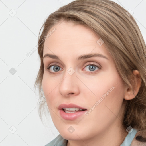 Joyful white young-adult female with medium  brown hair and blue eyes