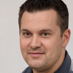 Joyful white adult male with short  brown hair and brown eyes