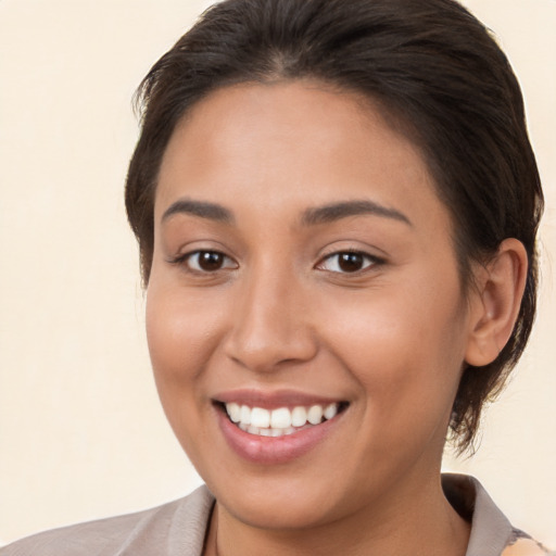 Joyful white young-adult female with medium  brown hair and brown eyes