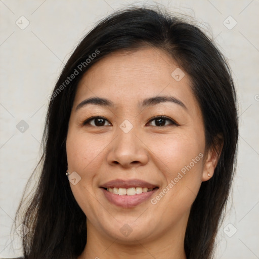 Joyful latino adult female with medium  brown hair and brown eyes