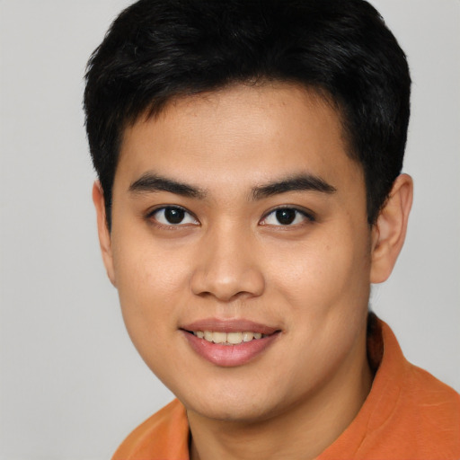 Joyful asian young-adult male with short  brown hair and brown eyes