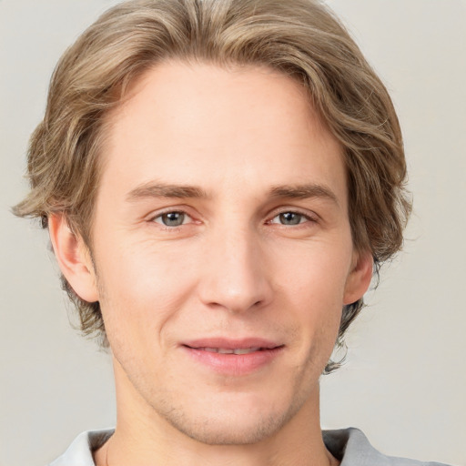 Joyful white young-adult male with medium  brown hair and brown eyes