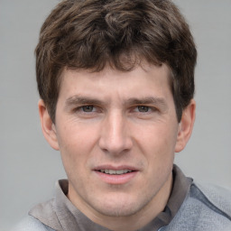 Joyful white adult male with short  brown hair and grey eyes