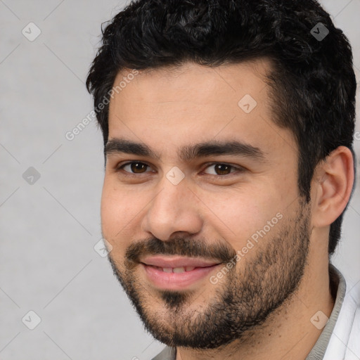 Joyful white young-adult male with short  black hair and brown eyes