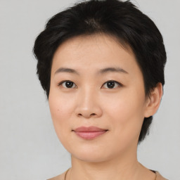 Joyful asian young-adult female with short  brown hair and brown eyes