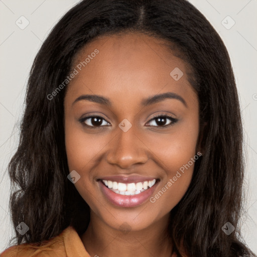 Joyful black young-adult female with long  brown hair and brown eyes