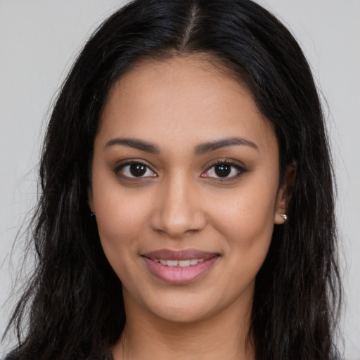 Joyful latino young-adult female with long  brown hair and brown eyes