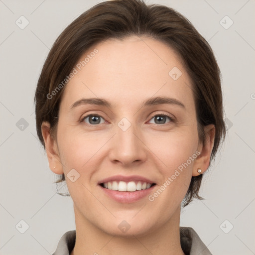 Joyful white young-adult female with medium  brown hair and grey eyes