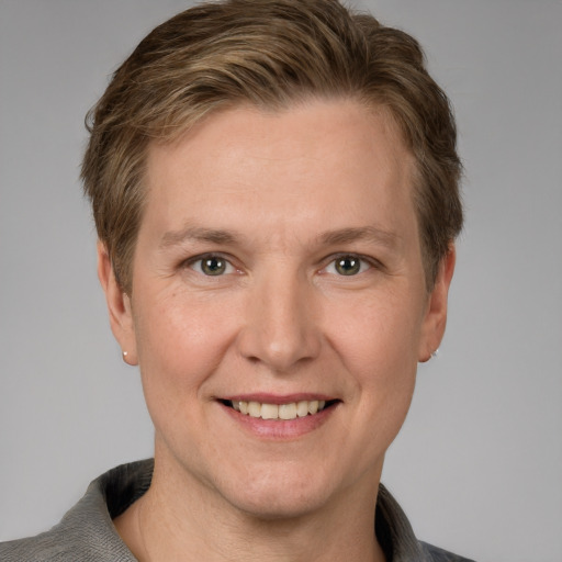 Joyful white adult male with short  brown hair and grey eyes