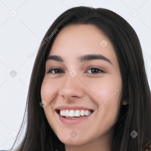 Joyful white young-adult female with long  black hair and brown eyes