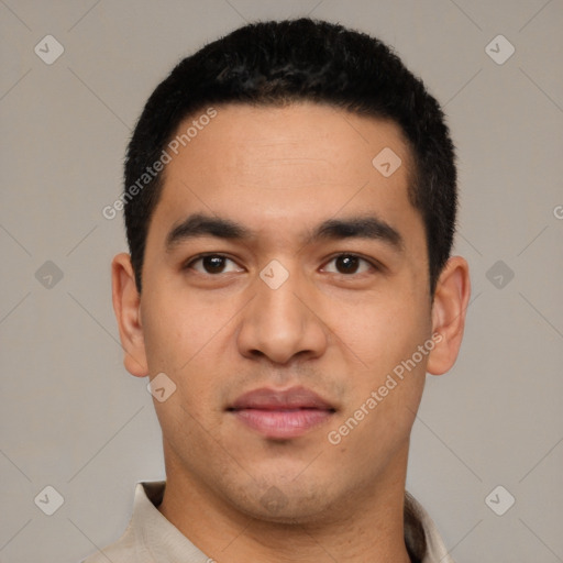 Joyful latino young-adult male with short  black hair and brown eyes