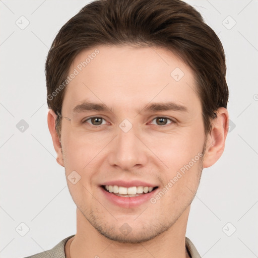 Joyful white young-adult male with short  brown hair and grey eyes